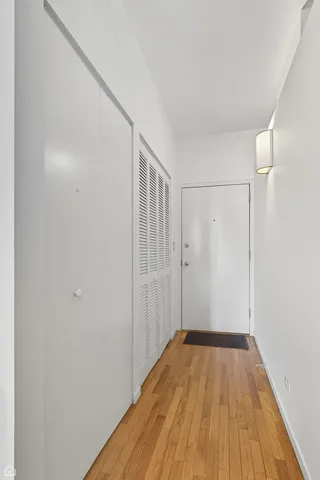 a view of a room with wooden floor