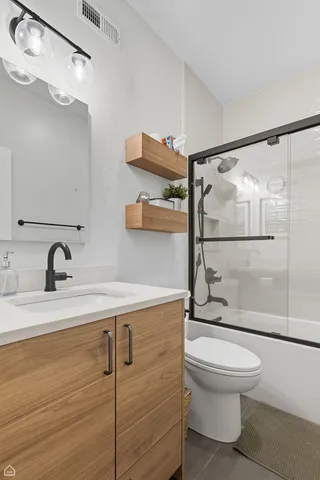 a bathroom with a toilet sink and shower