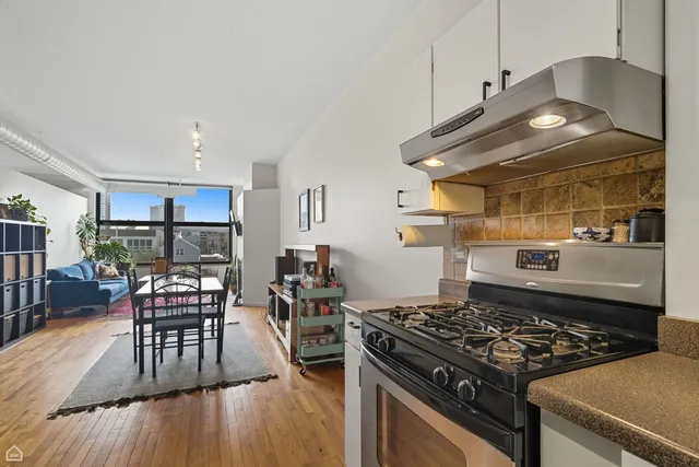 a kitchen with a stove a table and chairs in it