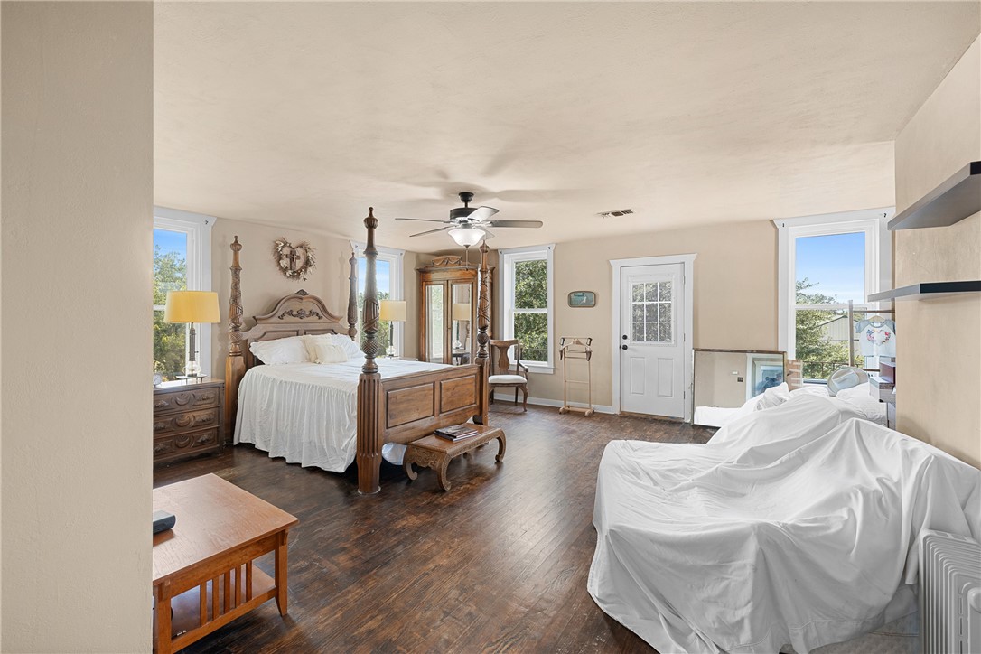 10415 McKnight Road Brenham, TX 77833 - Photo 19 of 23 a bedroom with furniture and a large window