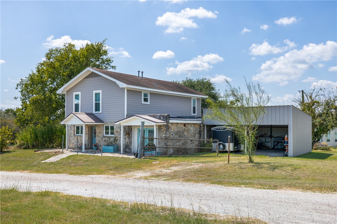 10415 McKnight Road Brenham, TX 77833 - Photo 22 of 23 a view of a house with a patio and a yard