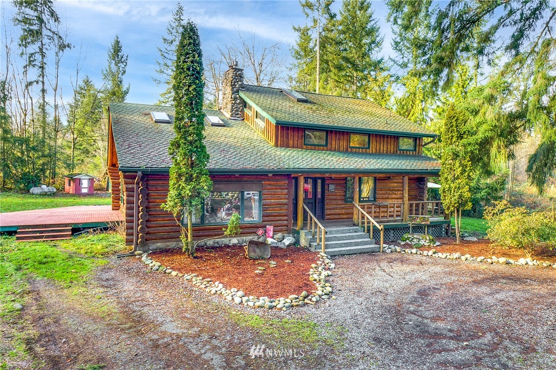 27253 Webster Road East Graham, WA 98338 - Photo 1 of 32 a front view of a house with garden