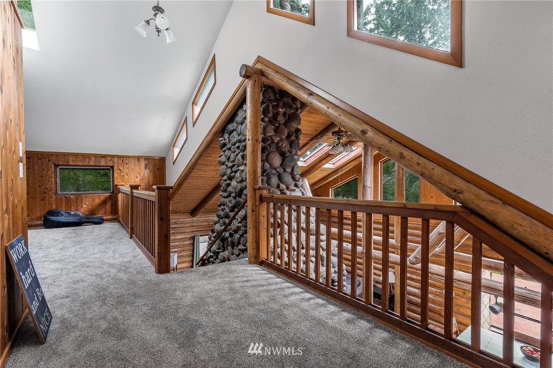 27253 Webster Road East Graham, WA 98338 - Photo 23 of 32 a view of staircase with lots of frames on wall