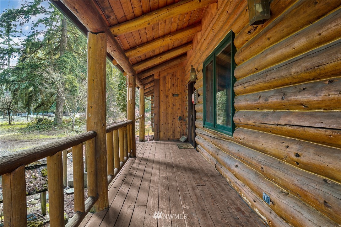 27253 Webster Road East Graham, WA 98338 - Photo 10 of 32 a view of a porch with wooden floor and stairs