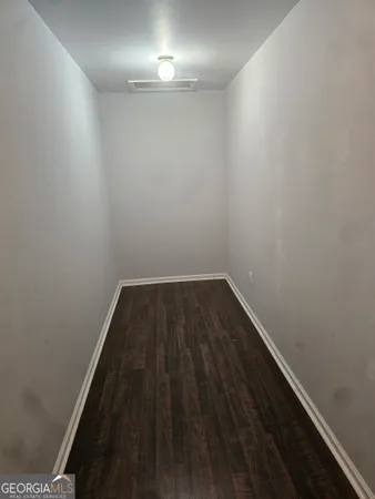 a view of wooden floor in a small room