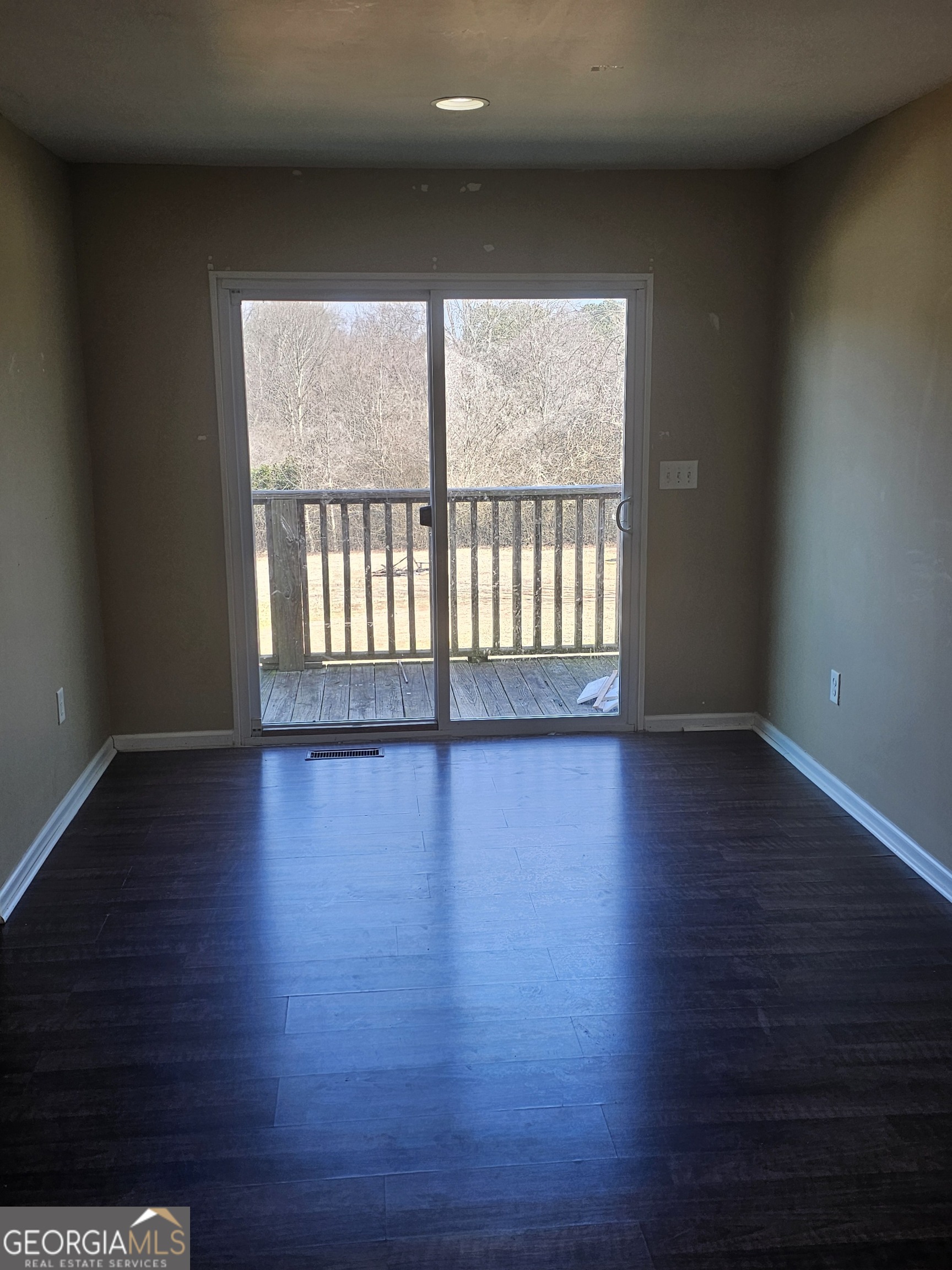 695 Frost Road Bowdon, GA 30108 - Photo 13 of 32 a view of an empty room with wooden floor and a window