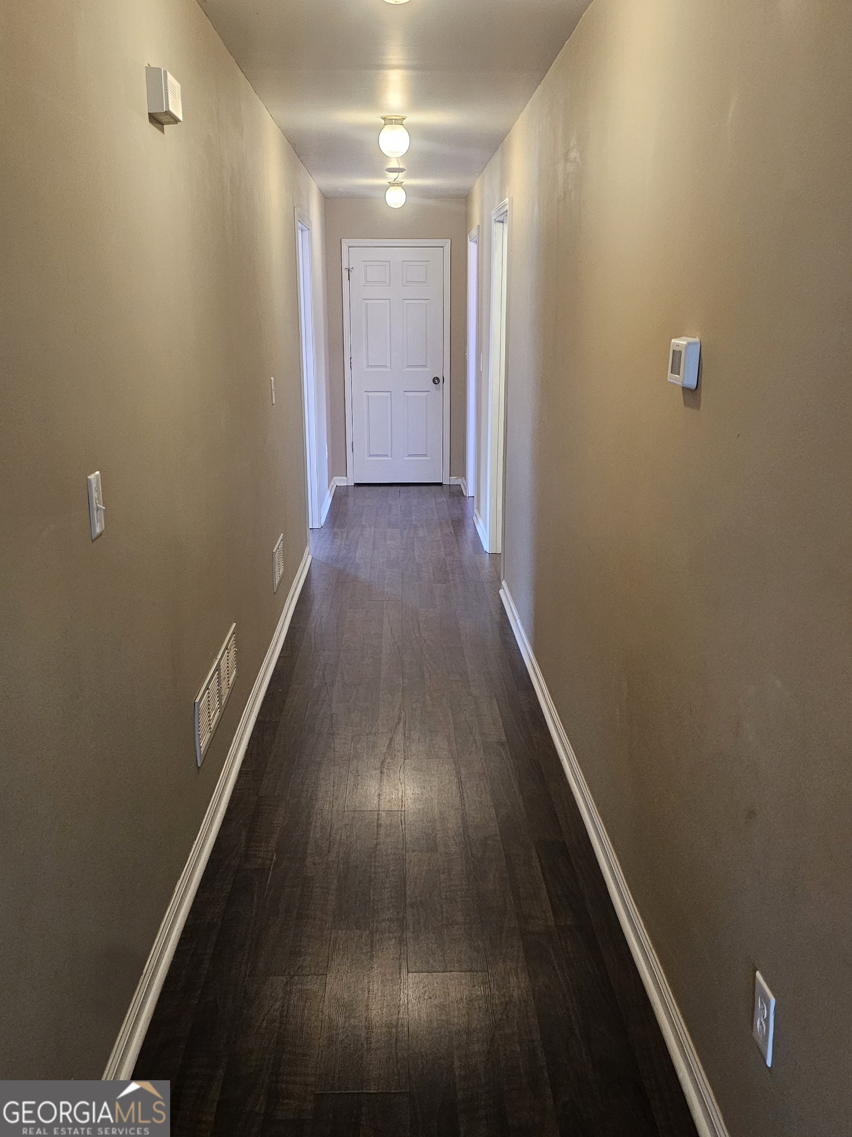 695 Frost Road Bowdon, GA 30108 - Photo 14 of 32 a view of a hallway with wooden floor