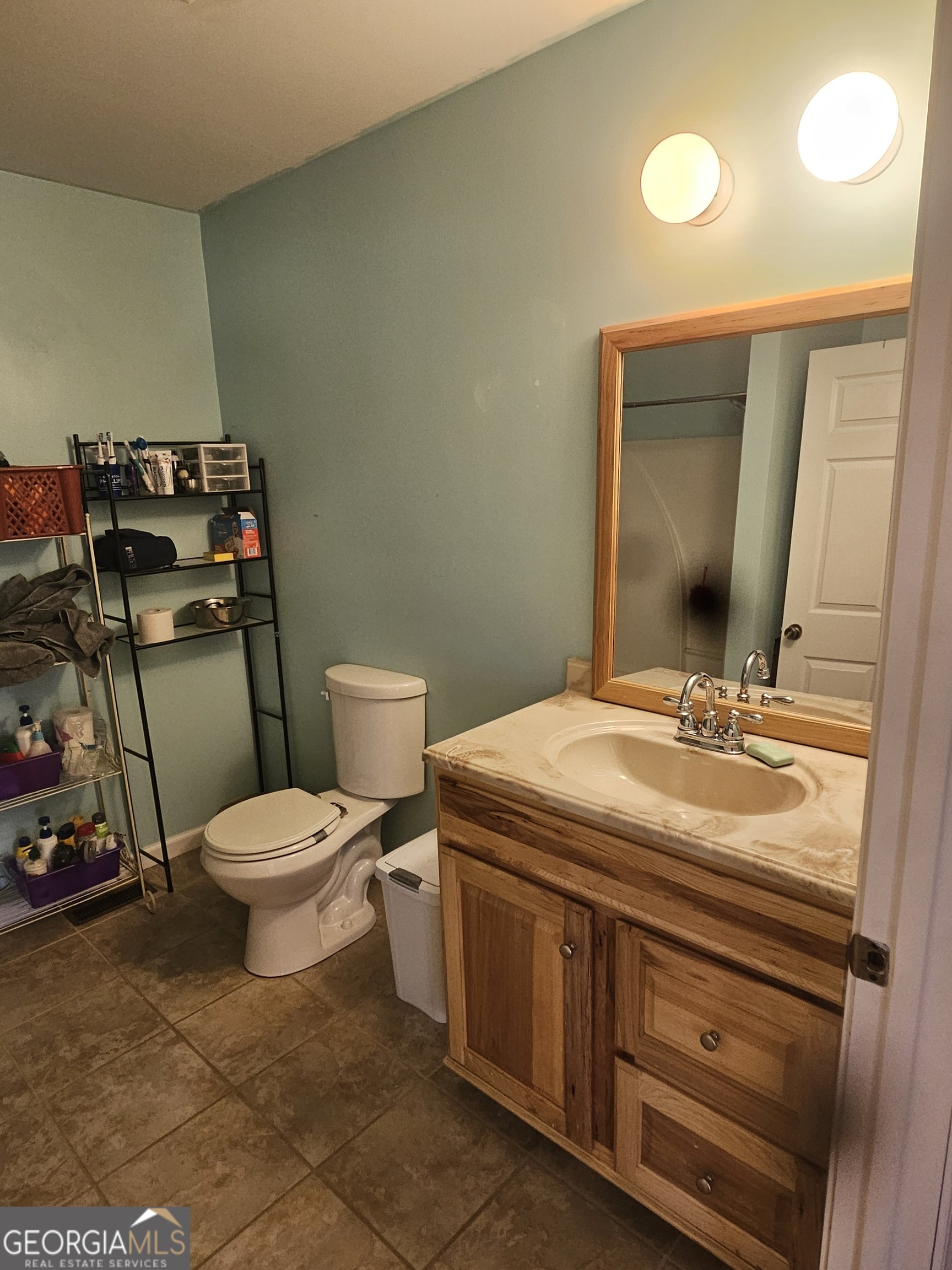 695 Frost Road Bowdon, GA 30108 - Photo 15 of 32 a bathroom with a toilet sink and mirror