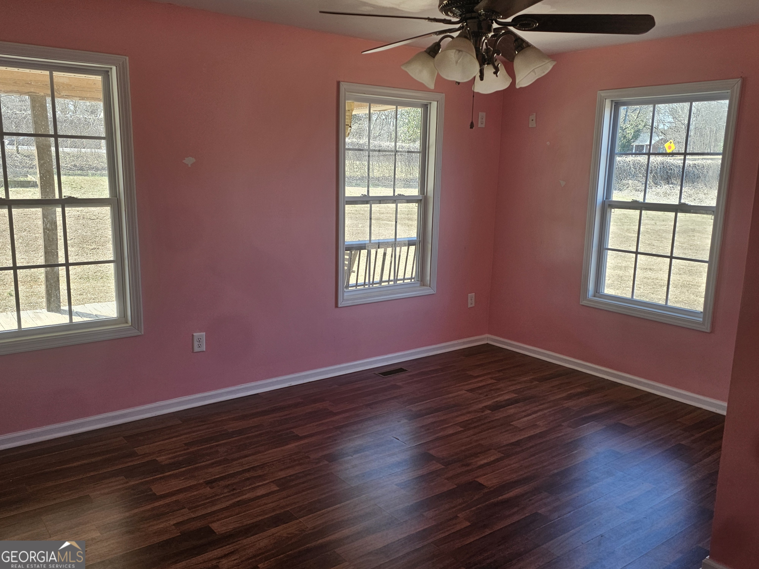 695 Frost Road Bowdon, GA 30108 - Photo 16 of 32 a view of an empty room with wooden floor and a window