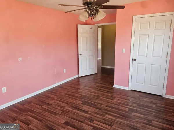 a view of a room with wooden floor and entryway