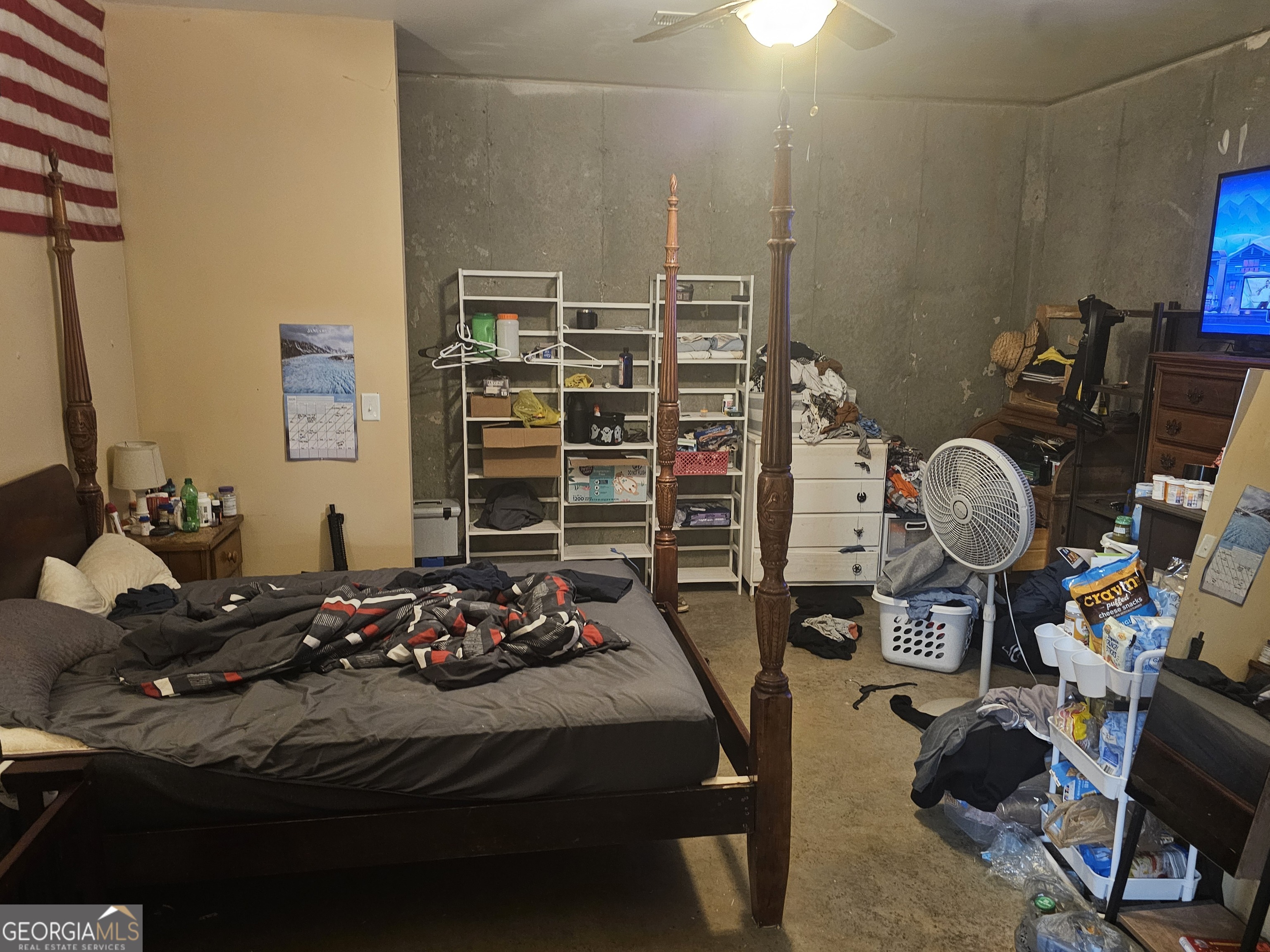 695 Frost Road Bowdon, GA 30108 - Photo 22 of 32 a bedroom with a bed a table and a chandelier