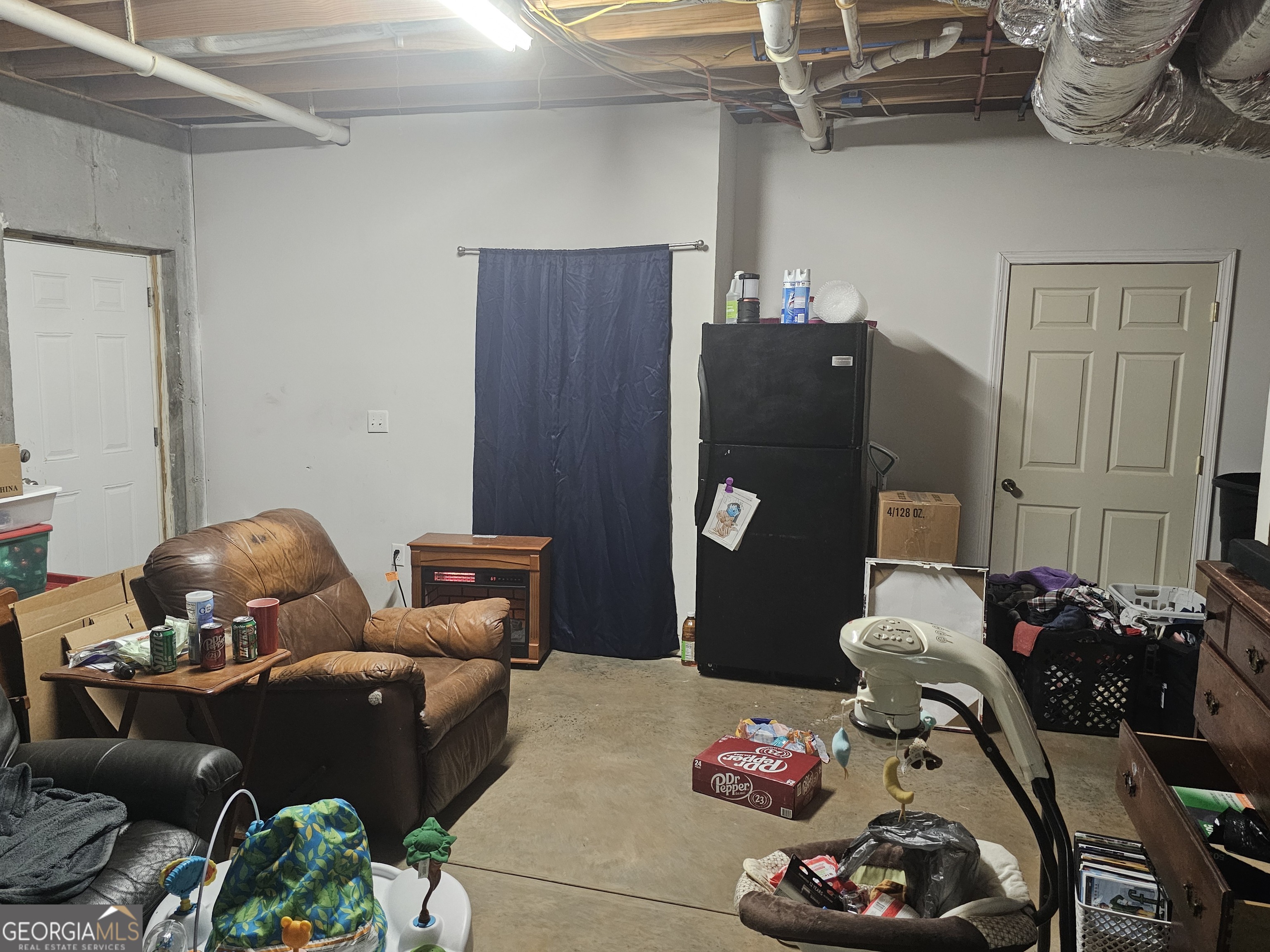 695 Frost Road Bowdon, GA 30108 - Photo 23 of 32 a bedroom with furniture and a chandelier