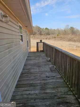 a view of a balcony with wooden floor and lake view