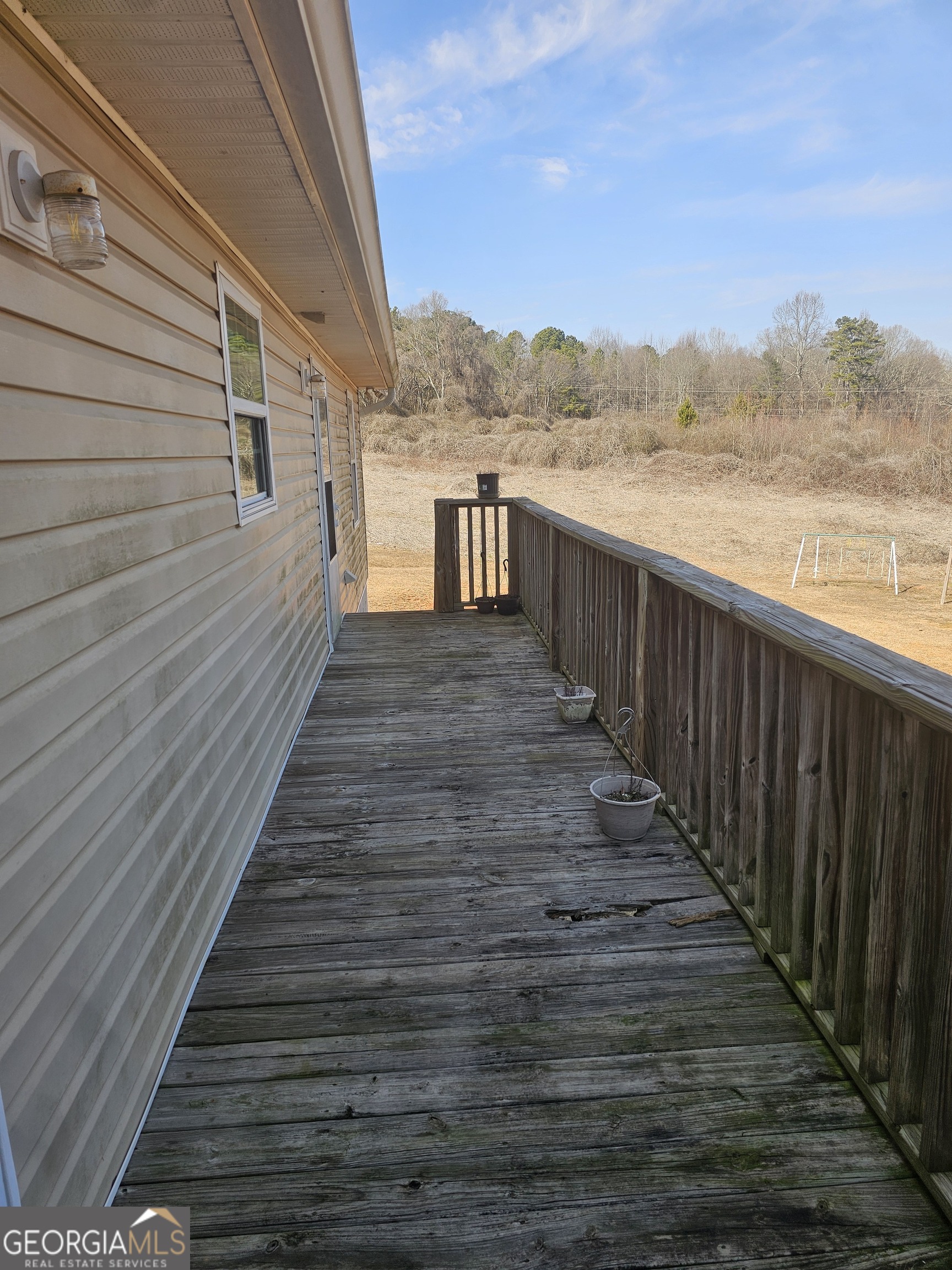 695 Frost Road Bowdon, GA 30108 - Photo 26 of 32 a view of a balcony with wooden floor and lake view