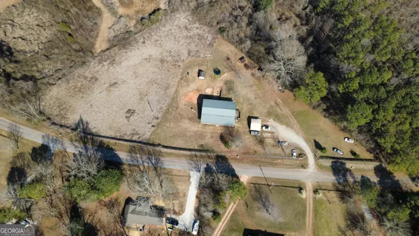 an aerial view of a house with a yard