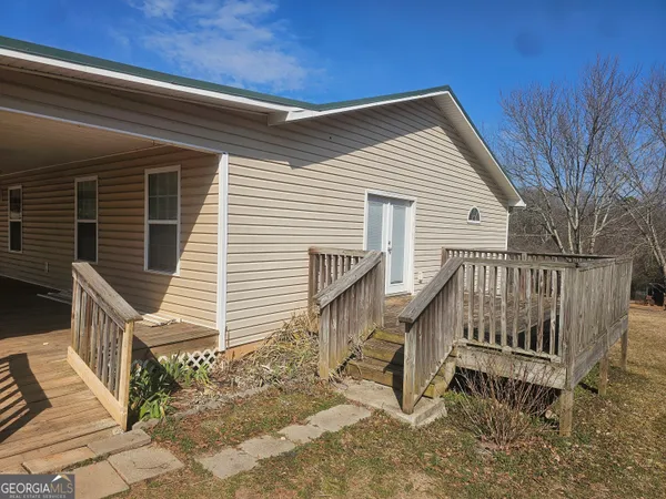 a view of a house with wooden fence