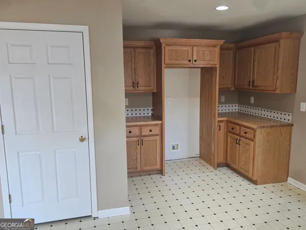 a kitchen with a refrigerator stove and cabinets