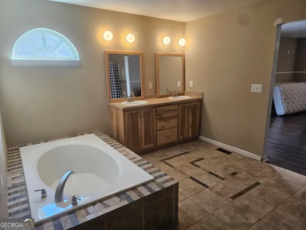 a bathroom with a sink and mirror