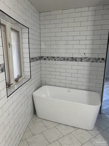 a bathroom with a granite countertop toilet sink and mirror