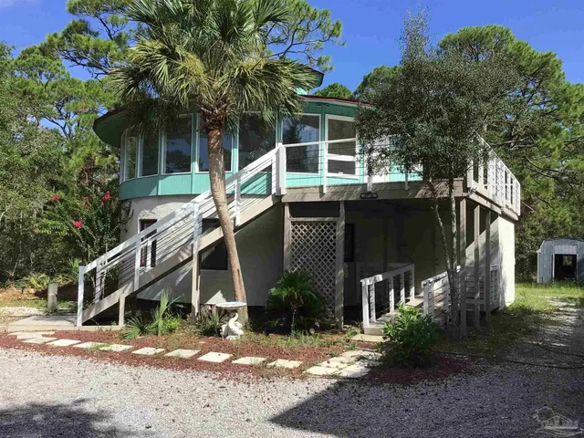 a house that has a tree in front of the house