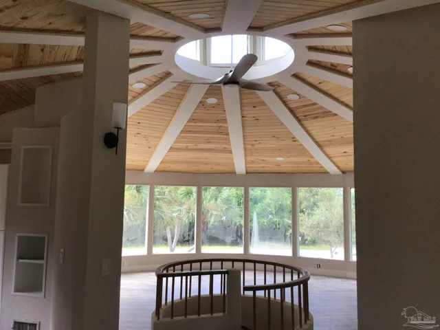 a view of staircase with a ceiling fan