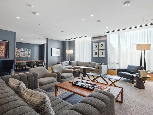 a living room with furniture ceiling fan and a window