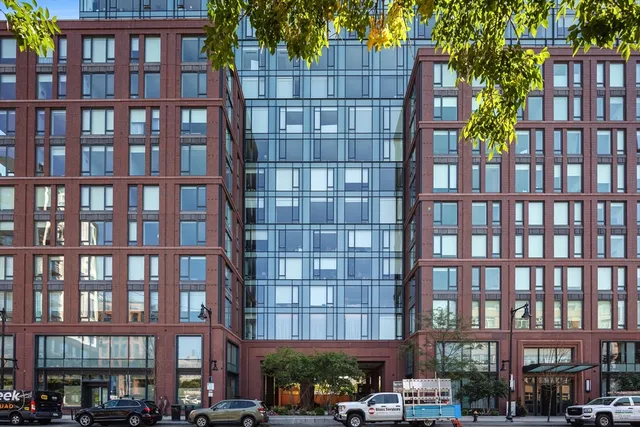 a front view of a building with a yard