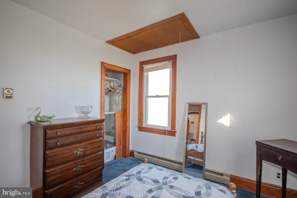 a view of room with closet and wooden floor