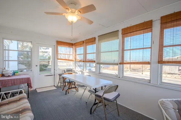 a dining room with furniture a chandelier and a rug