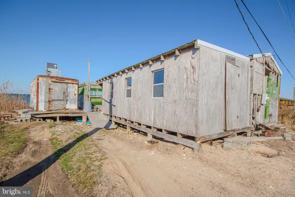 a view of a backyard with wooden fence