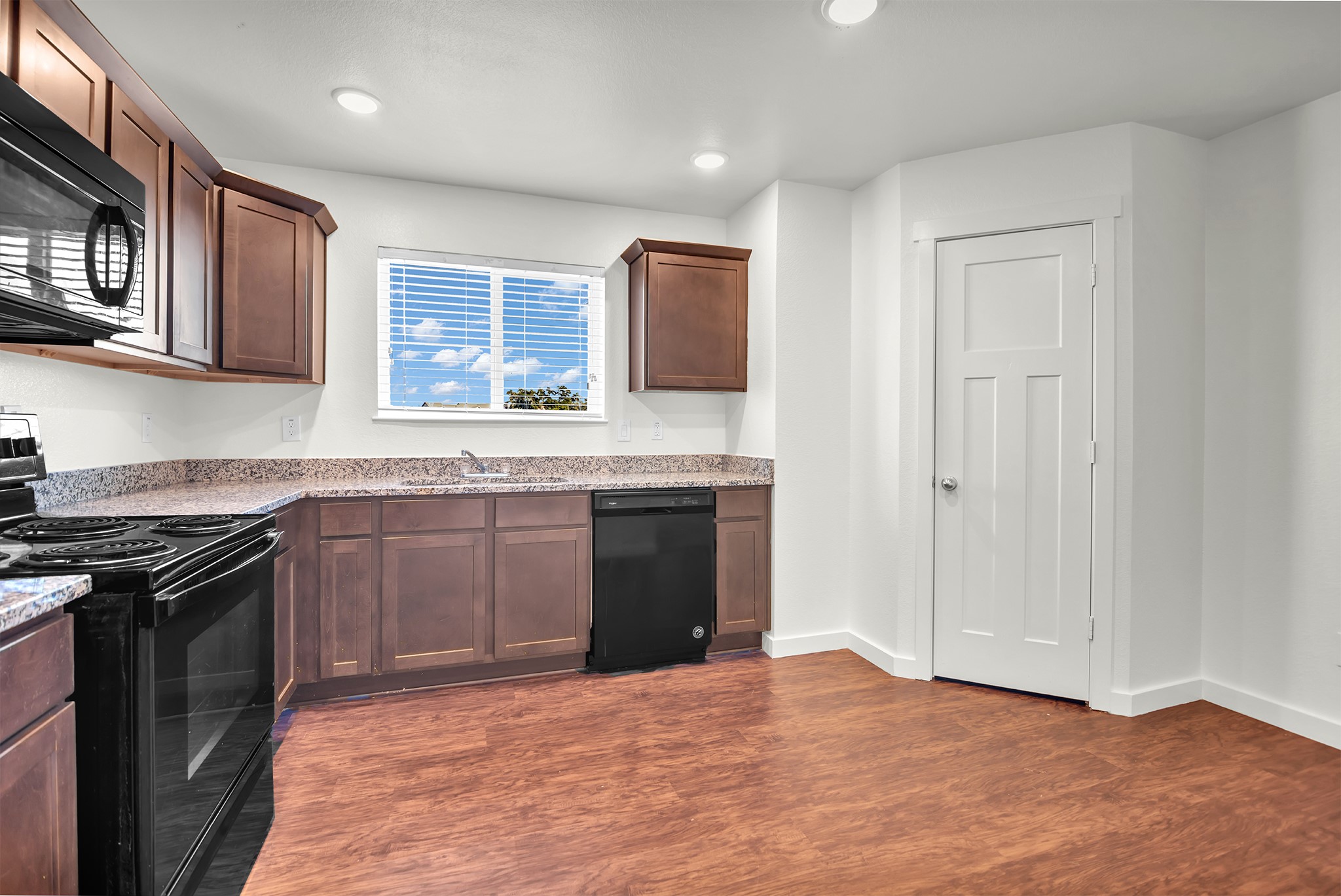 21155 Gosling Road, Unit 16B Spring, TX 77388 - Photo 7 of 16 a kitchen with stainless steel appliances granite countertop a stove a sink and a refrigerator