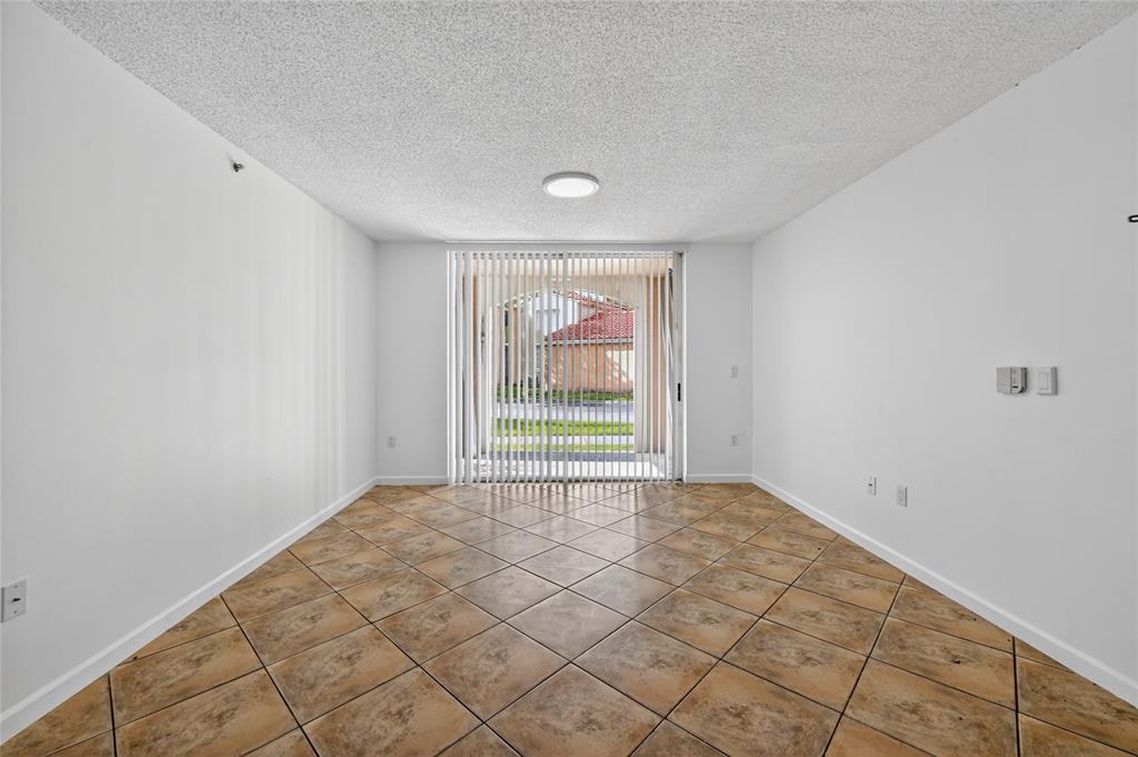 2011 Renaissance Boulevard, Unit 101 Miramar, FL 33025 - Photo 13 of 32 a view of an empty room and window