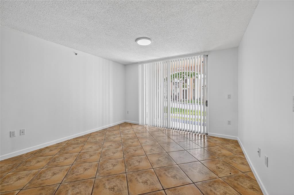 2011 Renaissance Boulevard, Unit 101 Miramar, FL 33025 - Photo 14 of 32 a view of an empty room with a window
