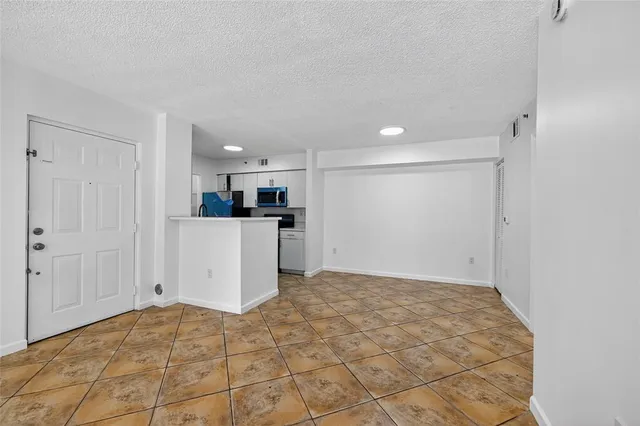a view of a kitchen with microwave and cabinets