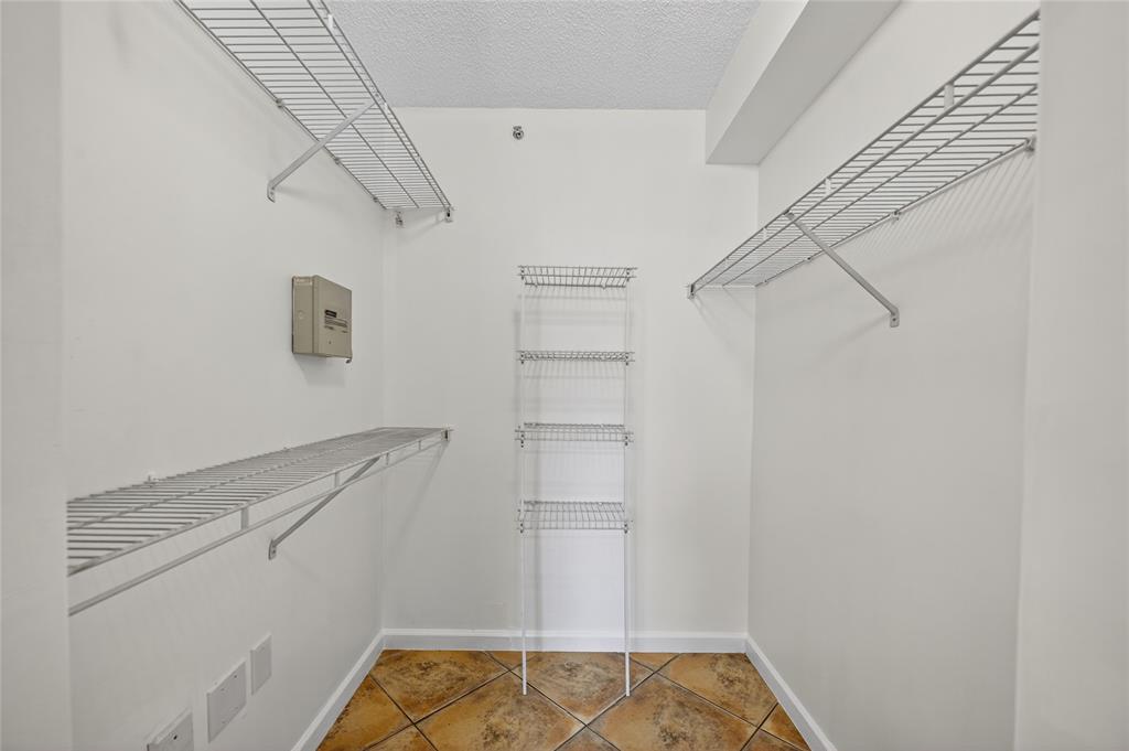 2011 Renaissance Boulevard, Unit 101 Miramar, FL 33025 - Photo 24 of 32 a view of walk in closet with empty racks