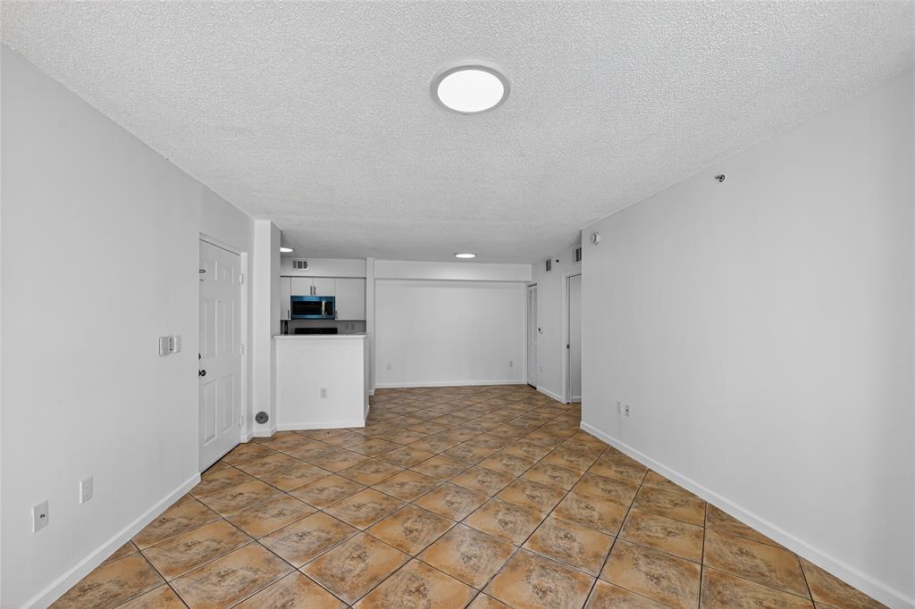 2011 Renaissance Boulevard, Unit 101 Miramar, FL 33025 - Photo 26 of 32 a view of a kitchen with a sink and a refrigerator