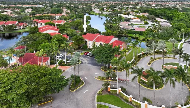 an aerial view of residential houses with outdoor space and street view