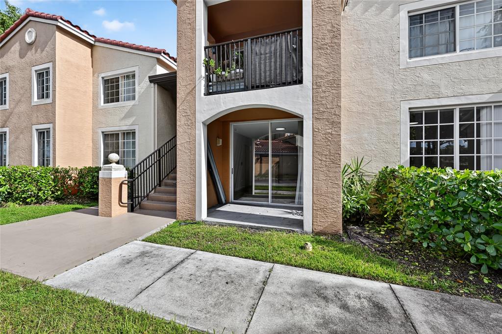 2011 Renaissance Boulevard, Unit 101 Miramar, FL 33025 - Photo 3 of 32 a front view of a house with garden