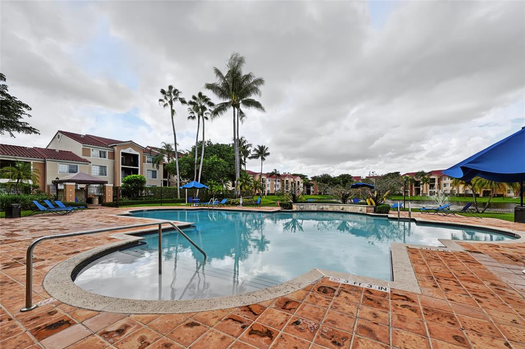 2011 Renaissance Boulevard, Unit 101 Miramar, FL 33025 - Photo 5 of 32 a swimming pool with outdoor seating and lake view