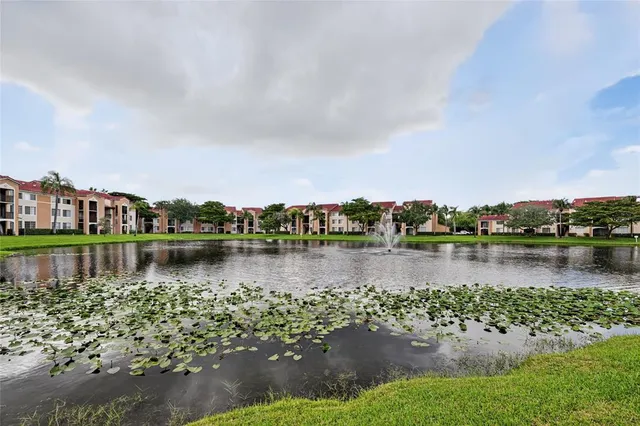 a view of a lake with houses in the back