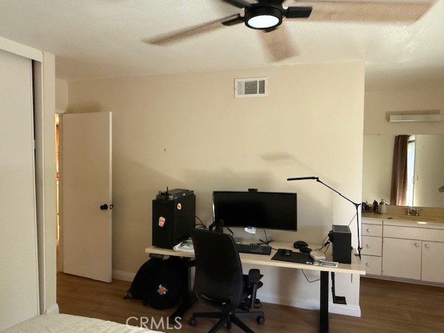 14172 Raintree Road Tustin, CA 92780 - Photo 19 of 27 a view of a workspace with furniture and wooden floor