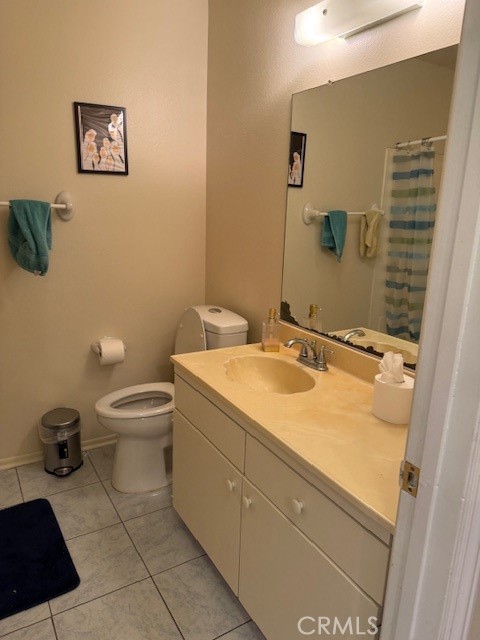 14172 Raintree Road Tustin, CA 92780 - Photo 24 of 27 a bathroom with a granite countertop toilet and a sink