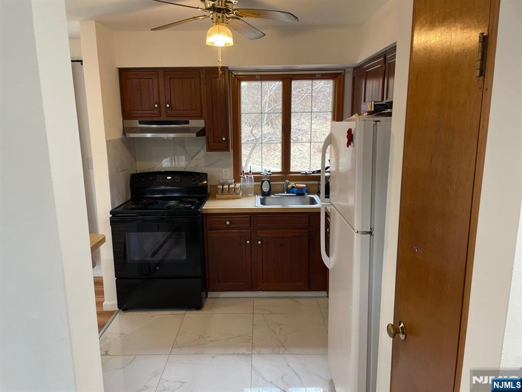 154 Cork Hill Road Franklin, NJ 07416 - Photo 8 of 35 a kitchen with stainless steel appliances granite countertop a refrigerator a stove a sink and dishwasher
