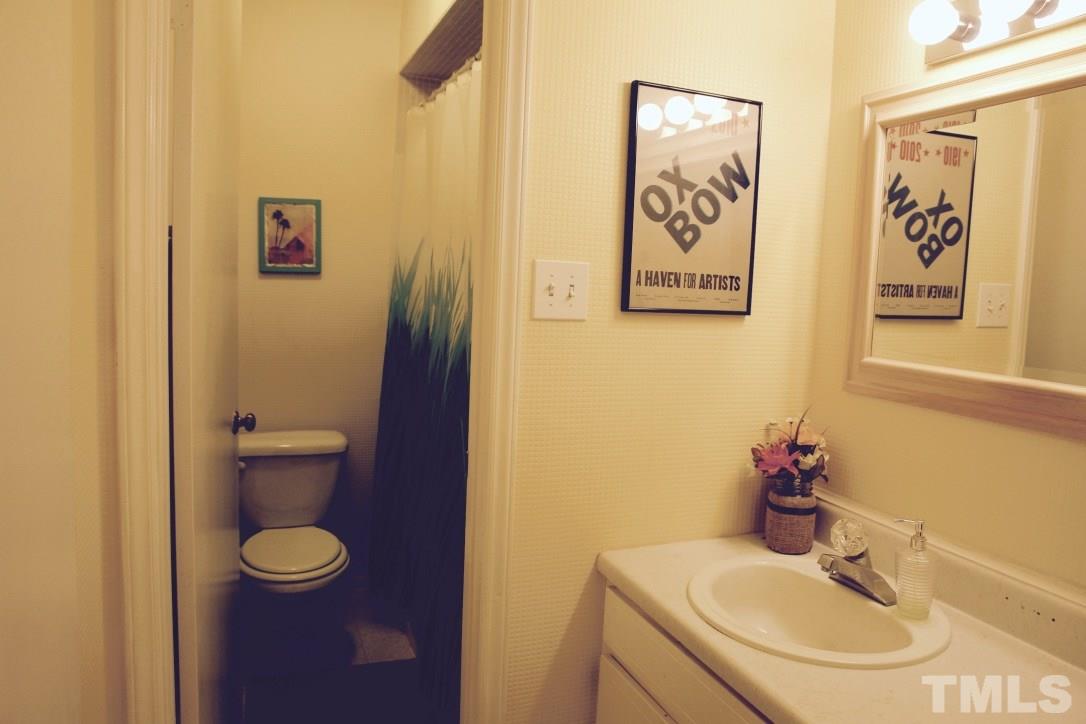 6451 New Market Way, Unit 6451 Raleigh, NC 27615 - Photo 11 of 15 This full bathroom nicely accommodates the two bedrooms toward the back of the unit.