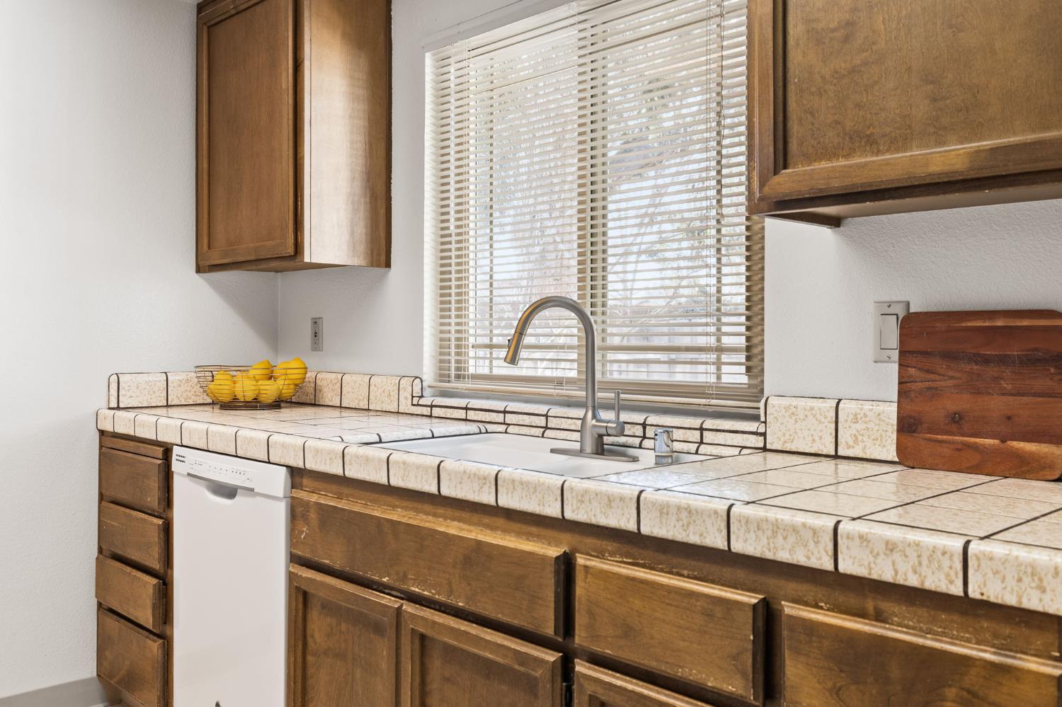 10938 Anza Way Rancho Cordova, CA 95670 - Photo 12 of 37 a kitchen with a sink and a window
