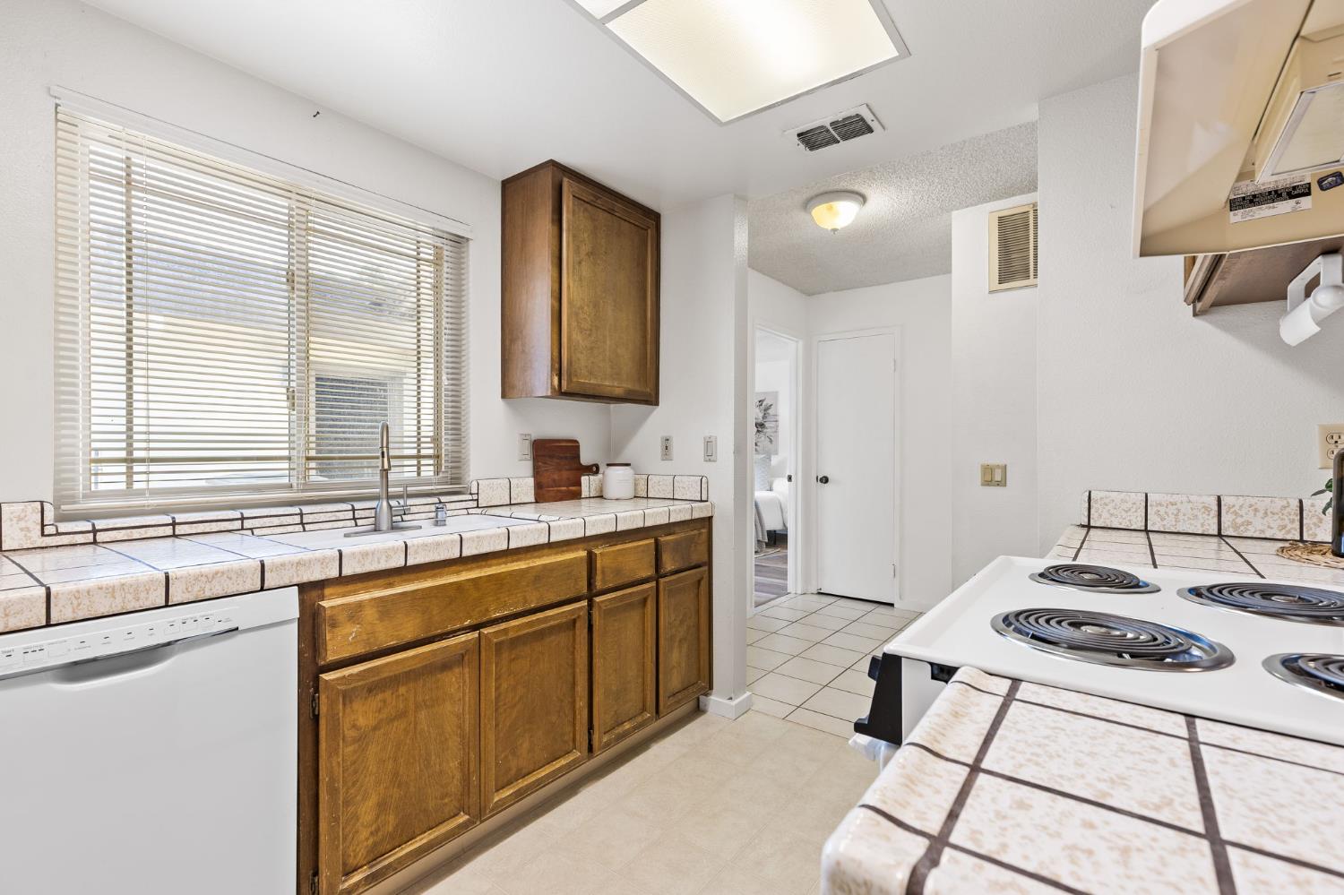10938 Anza Way Rancho Cordova, CA 95670 - Photo 13 of 37 a kitchen with a sink stove and cabinets