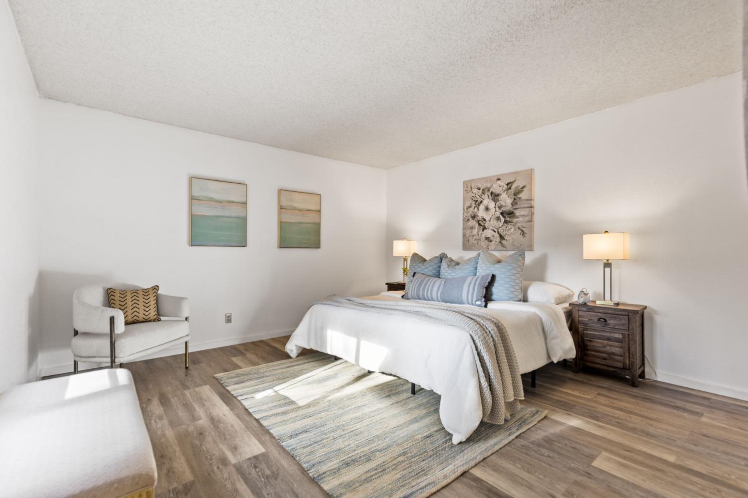 10938 Anza Way Rancho Cordova, CA 95670 - Photo 15 of 37 a spacious bedroom with a bed and a lamp