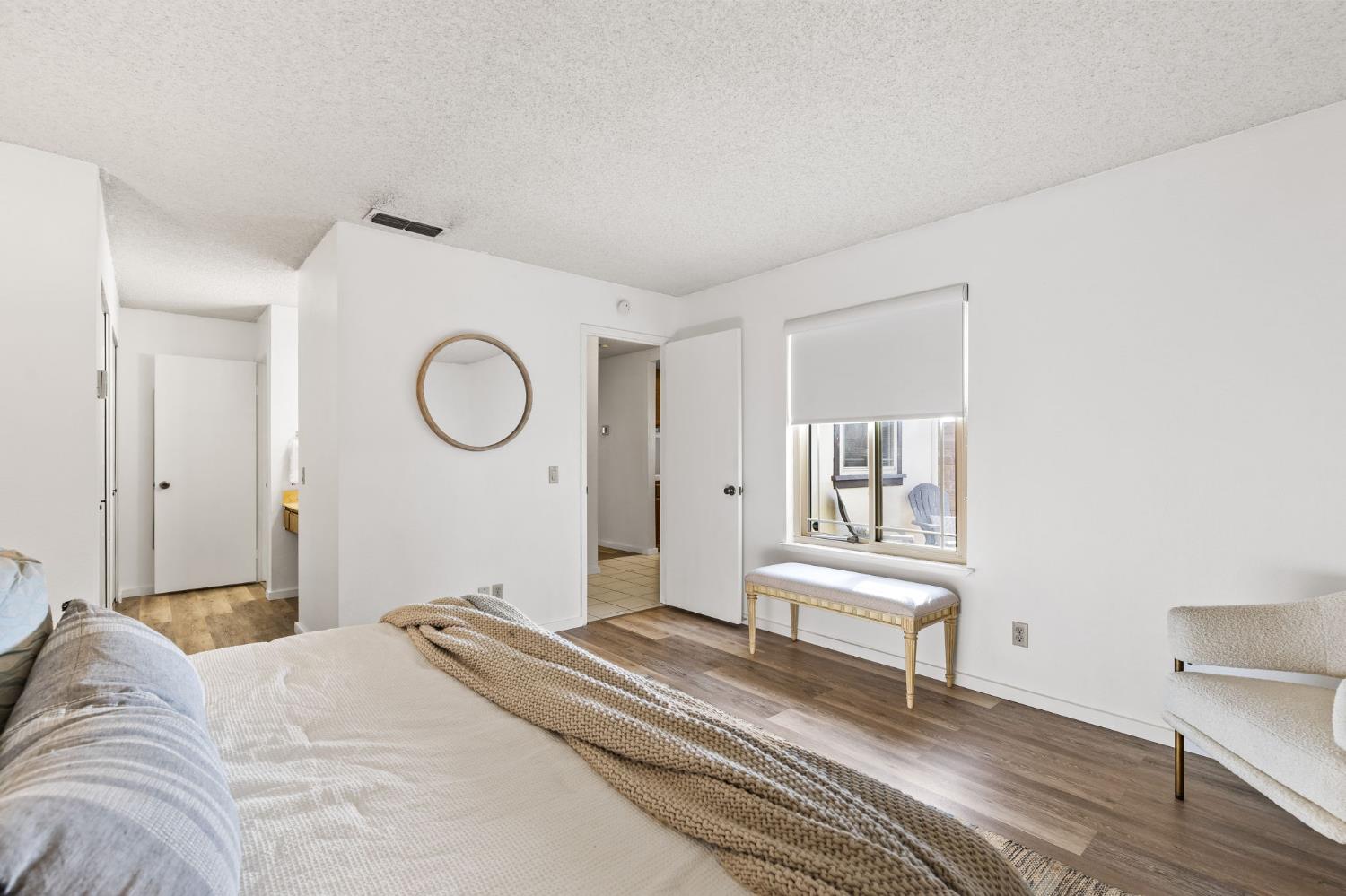 10938 Anza Way Rancho Cordova, CA 95670 - Photo 17 of 37 a bedroom with a bed and a chandelier