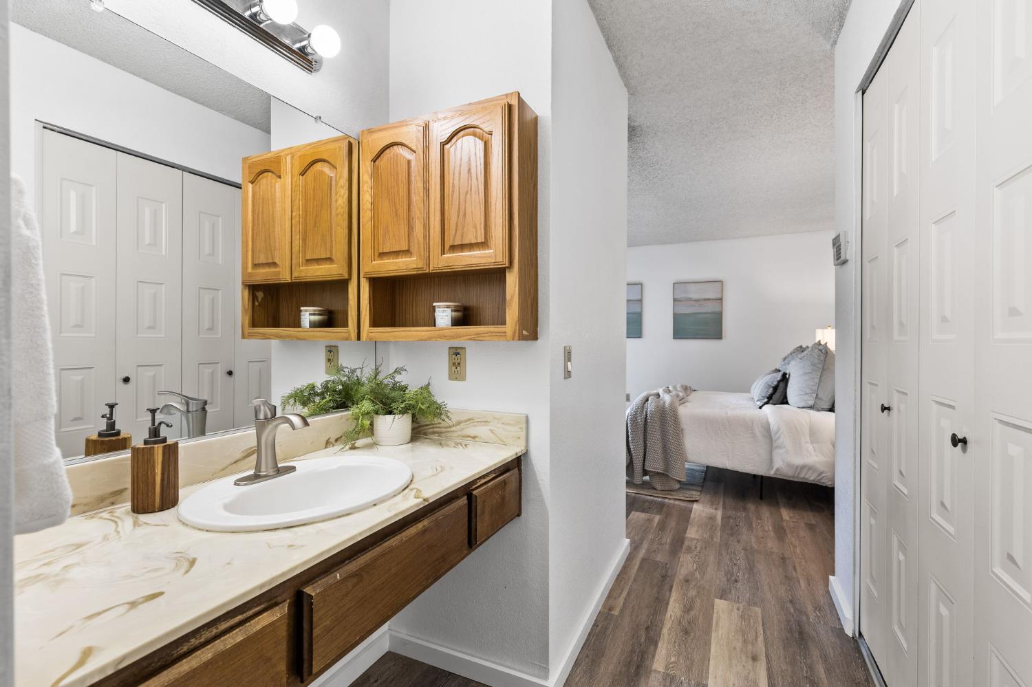 10938 Anza Way Rancho Cordova, CA 95670 - Photo 20 of 37 a en suite bathroom with a granite countertop tub sink and mirror