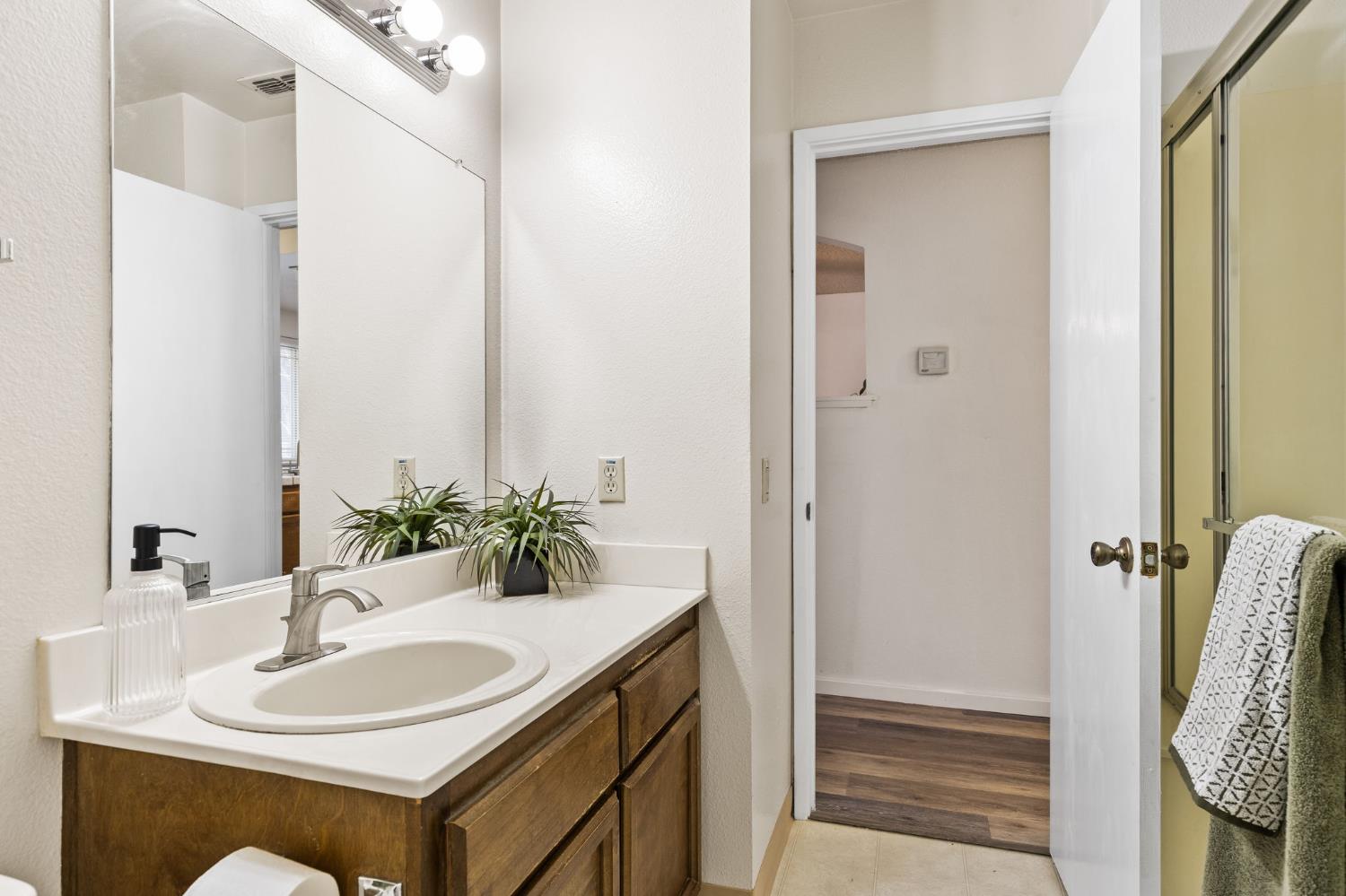 10938 Anza Way Rancho Cordova, CA 95670 - Photo 21 of 37 a bathroom with a sink and a mirror